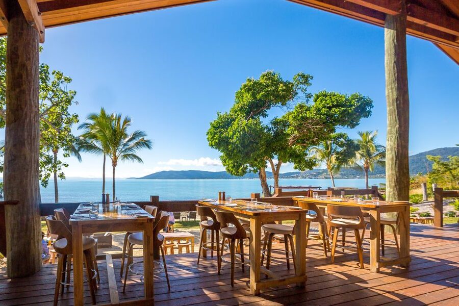Airlie Beach: Cedar Creek Falls & Northerlies Beach Day Trip - Northerlies Beach Bar and the Coral Sea view