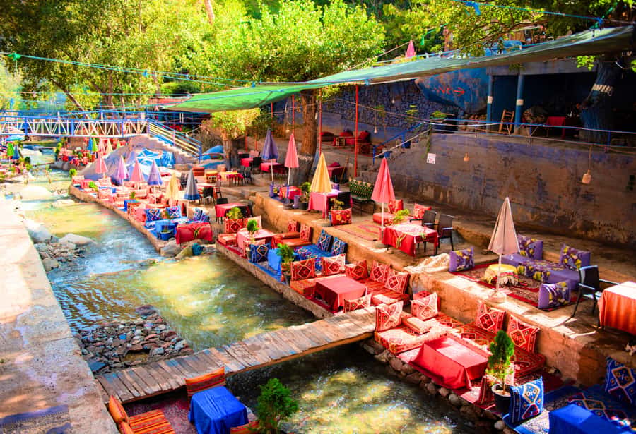 Marrakech: Ouzoud Waterfalls Trip, Guide & Boat + Lunch - A Wooden Boat Beneath the Spray