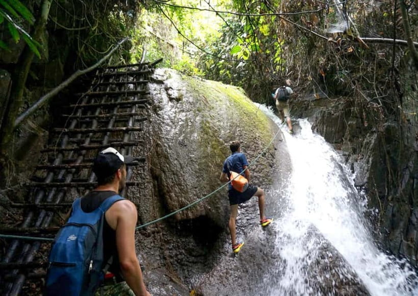 Nong Khiaw: 100 Waterfalls, Nam Ou & Khmu Village Day Tour - Climbing the cascades, one careful step at a time