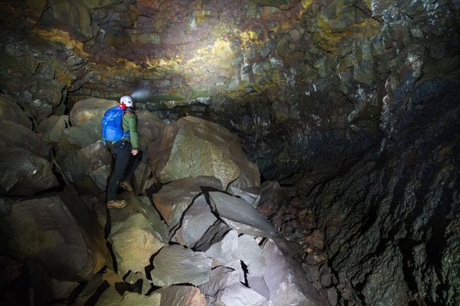 Raufarhólshellir: Lava Falls Adventure Tour - Crossing the first boulders in the dark